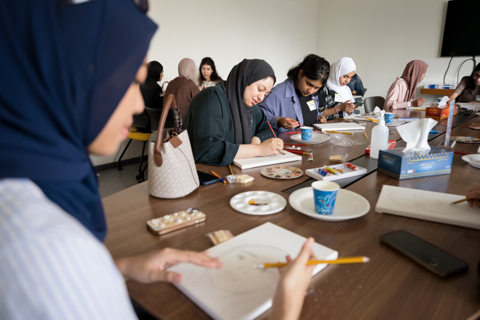 Attendees creating together at a hands-on workshop table