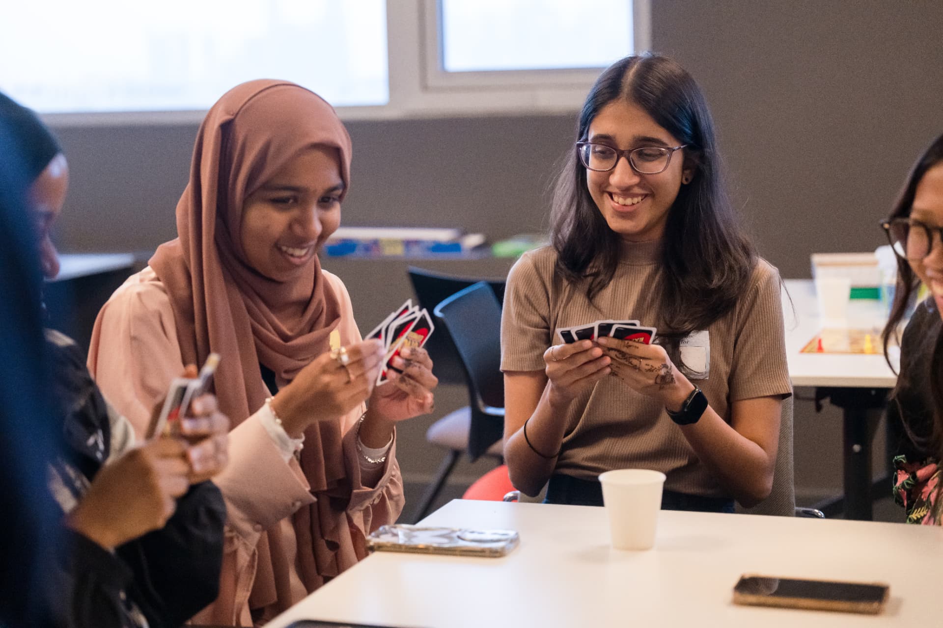 Two attendees unwinding over a card game